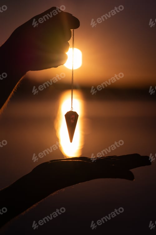 Preview: Pendulum seen from up close to against the light at a sunrise on a lake