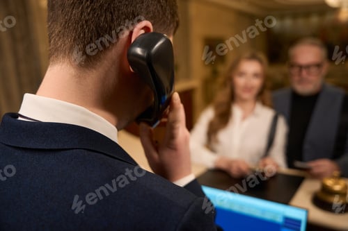 Preview: Receptionist is talking on the phone at the reception desk