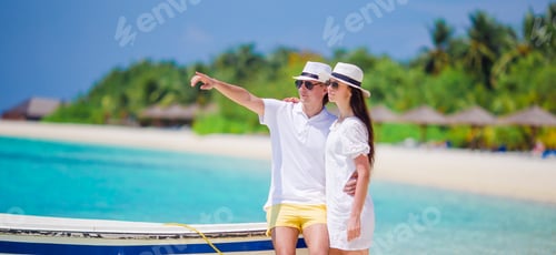 Preview: Young happy couple on white beach at summer vacation
