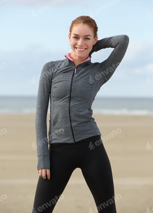 Preview: Smiling sportswoman standing outdoors