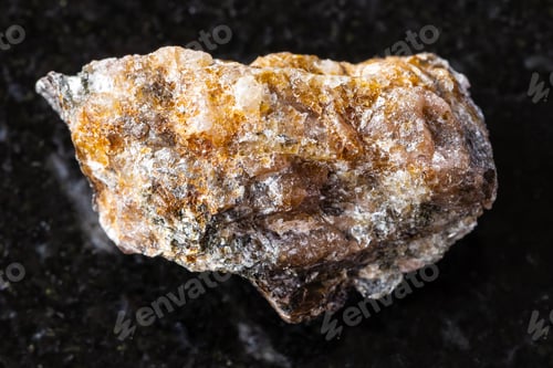 Preview: sample of raw andalusite mineral on black granite
