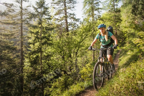 Preview: Woman mountain biking, Leermoos, Tyrol, Austria