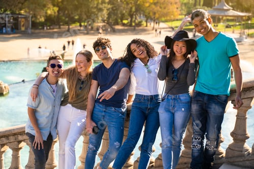 Preview: Group of young multiracial students smiling to the camera on some stairs