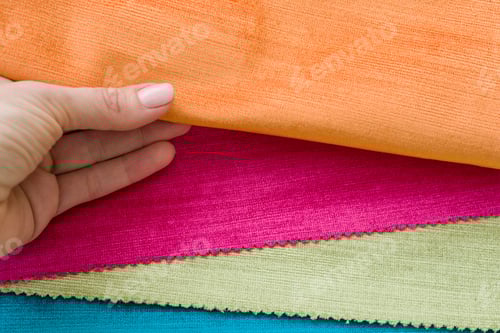 Preview: Colorful Textiles Arranged in Layers with Hand