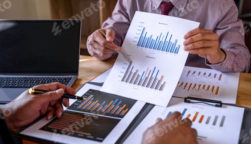 Preview: Marketing analysis two business people discussing Financial charts to analyze profits, investment re