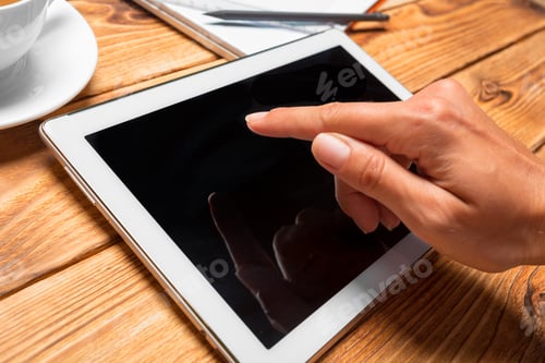 Preview: woman holding blank tablet device over a wooden workspace table