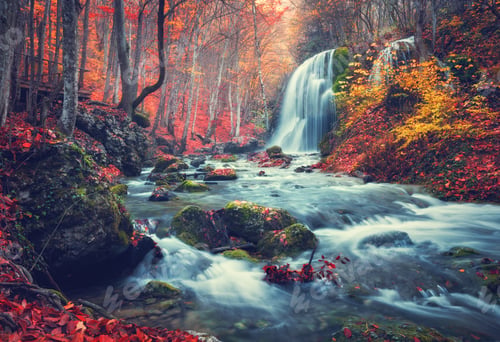 Preview: Autumn forest with waterfall at mountain river at sunset