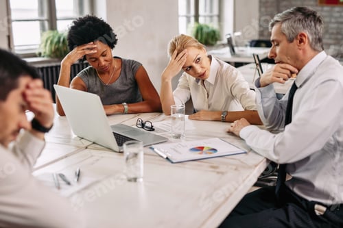 Preview: Group of displeased business people having a meeting in the office.