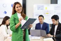 Preview: Portrait of a attractive business woman in a business office meeting room.