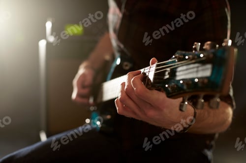 Preview: Close Up Of Man Playing Electric Guitar In Studio