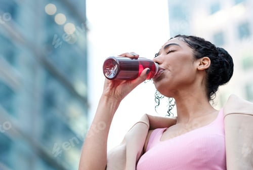 Preview: Portrait of young fitness woman drinking energy drink.