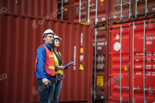 Preview: Workers inspect shipping containers at a logistics facility during daylight hours