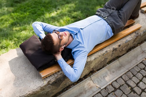 Preview: Young handsome man in blue shirt and sunglasses with wireless ea