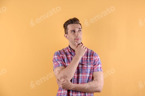 Preview: Handsome young man on color background