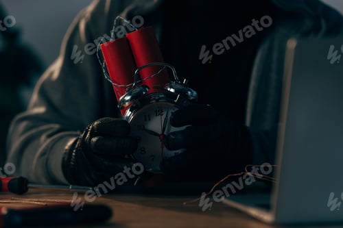 Preview: Partial view of criminal in leather gloves holding bomb