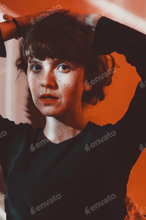 Preview: Artistic portrit of a young woman posing and crossed by ligths