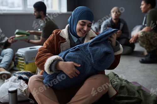 Preview: Middle Eastern Woman Playing With Baby at Refugee Shelter