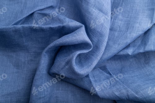 Preview: Fragment of blue linen tissue. Top view, natural textile background.