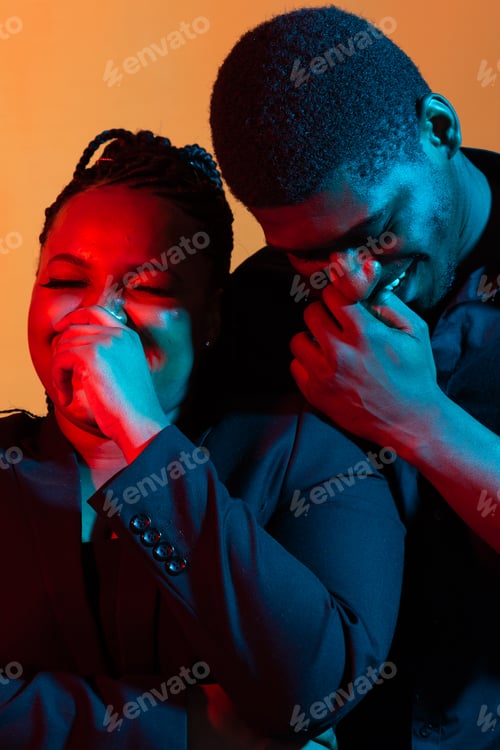Preview: Dark neon portrait of young african american man and woman. Red and blue light
