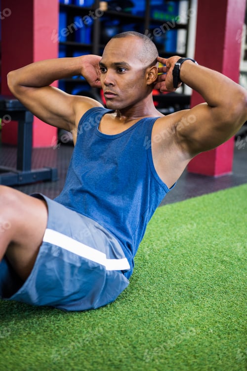 Preview: Serious Young Athlete Exercising In Gym