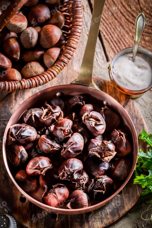 Preview: Roasted chestnuts with parsley on old wooden table