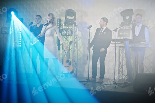 Preview: Musicial music live band performing on a stage with different lights.