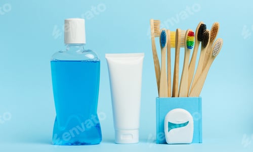 Preview: Mouthwash and toothpaste tube blue background