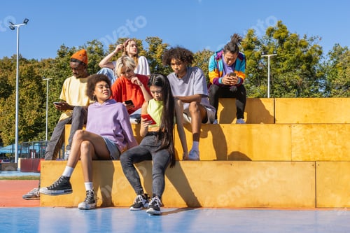 Preview: Multiracial group of young friends bonding outdoors