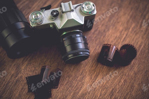 Preview: Retro photo camera on a wooden table. vintage style.