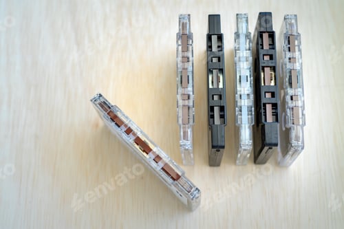 Preview: Set of old audio cassettes on wooden background