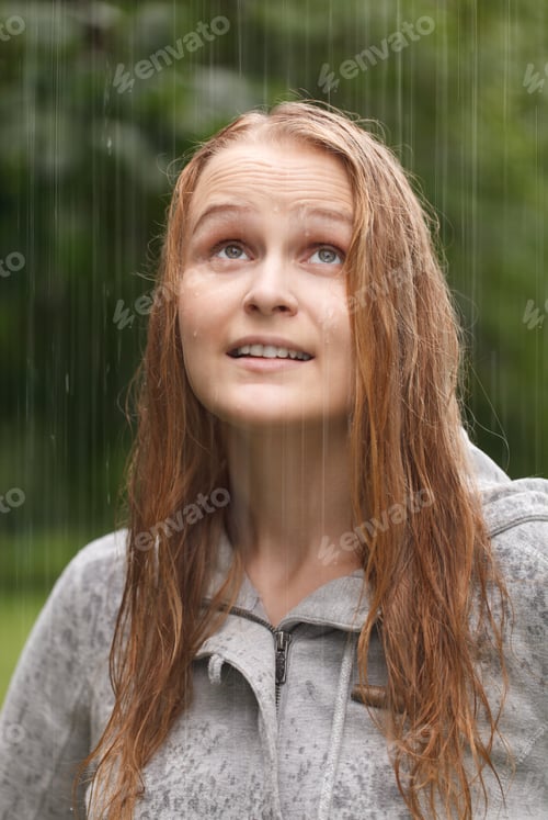 Preview: Girl enjoying rain in the park