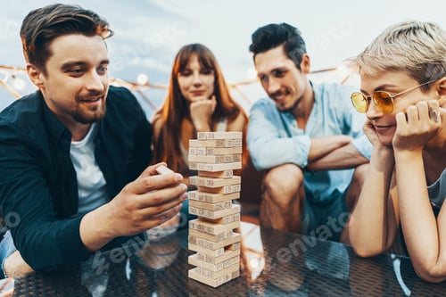 Preview: The company of young people playing jenga