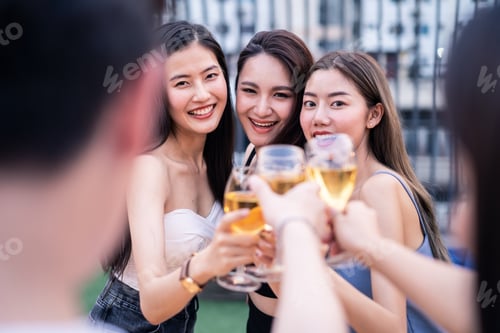 Preview: Group of Asian girl gang drinking beer alcohol and toasting glass, have party at rooftop restaurant