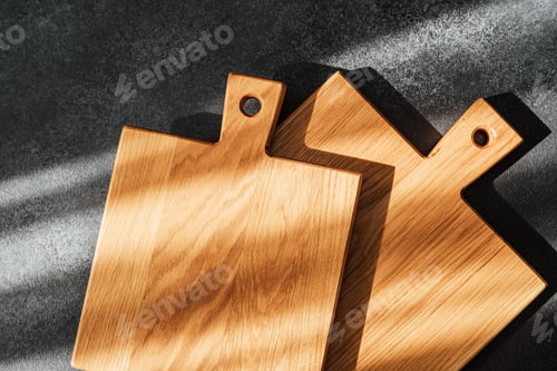 Preview: Wooden cutting boards arranged stylishly under natural light in a kitchen