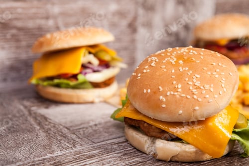 Preview: Delicious tasty burgers on wooden background
