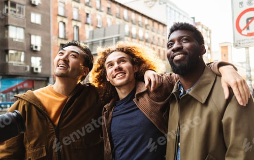 Preview: Group of happy multi ethnic friends looking up in the city