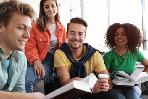 Preview: Group of young people studying at table in library