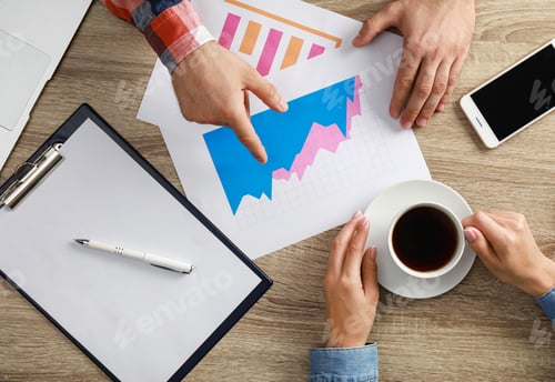 Preview: Business trainer and client working at table in office, top view
