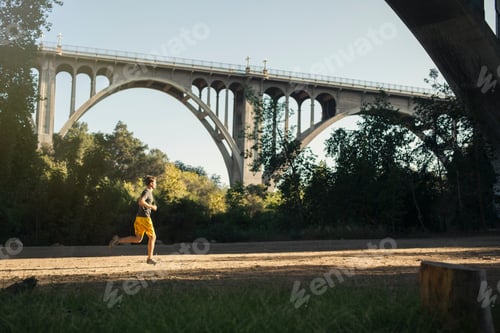 Preview: Jogger running, arch bridge in background, Arroyo Seco Park, Pasadena, California, USA
