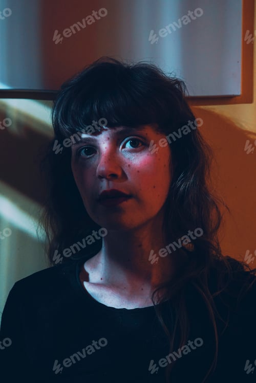 Preview: Artistic portrit of a young woman posing and crossed by ligths