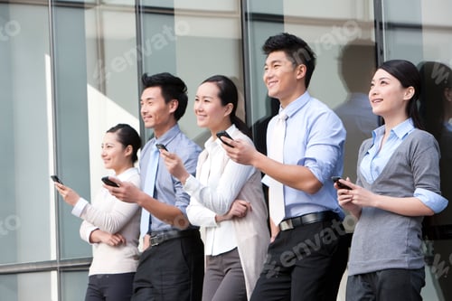 Preview: Chinese businesspeople leaning on the wall with mobile phones