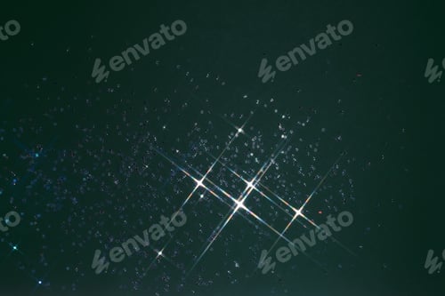 Preview: Abstract green background with sparkles in the shape of stars.