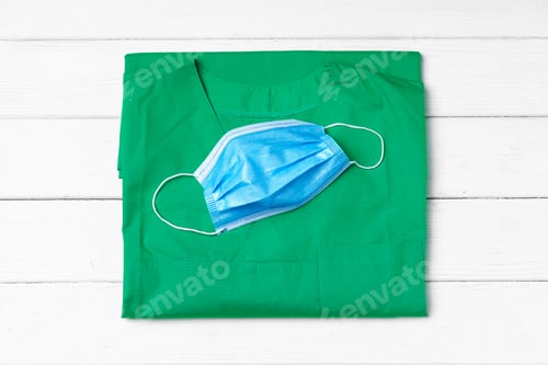 Preview: Doctor uniform with medical face mask close up