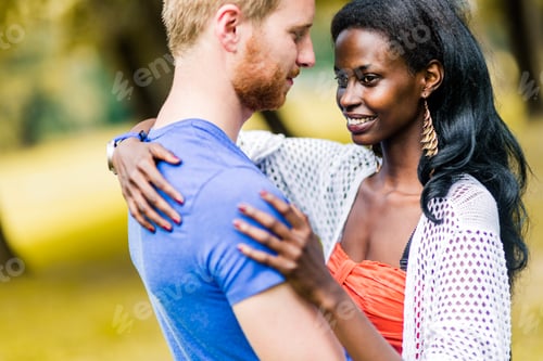 Preview: Couple in love hugging and kissing peacfully outdoors