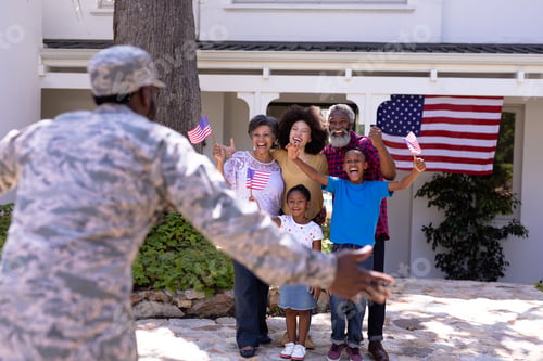Preview: Multi-generation mixed race family welcoming an African American man wearing military uniform