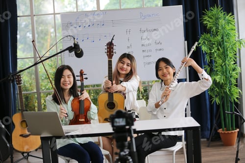 Preview: Young women musician is online training lesson classes playing guitar at home and play music.