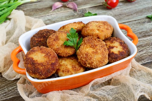Preview: Cutlets. Fried cutlets in a ceramic bowl on a wooden table.