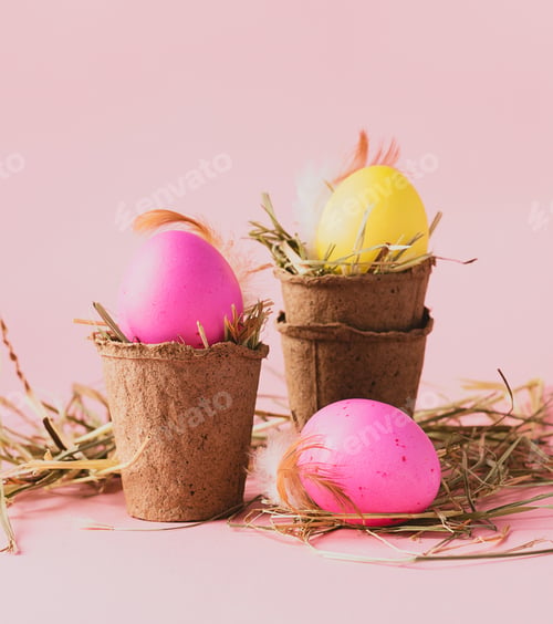 Preview: Happy easter concept. Festive spring composition of colored eggs in pots on a pink background. Copy