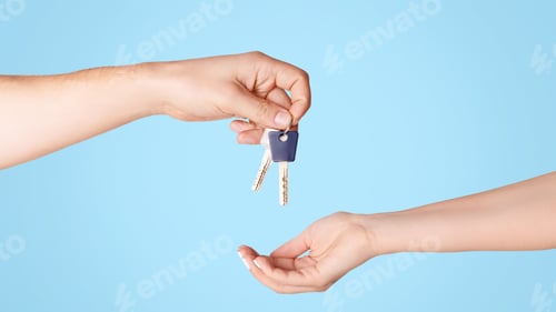 Preview: Real estate agent giving house keys to client against light background, close up of hands. Panorama