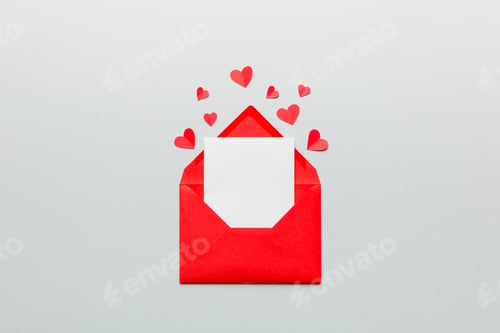 Preview: Red paper envelope with empty white card and heart on colored background. top view